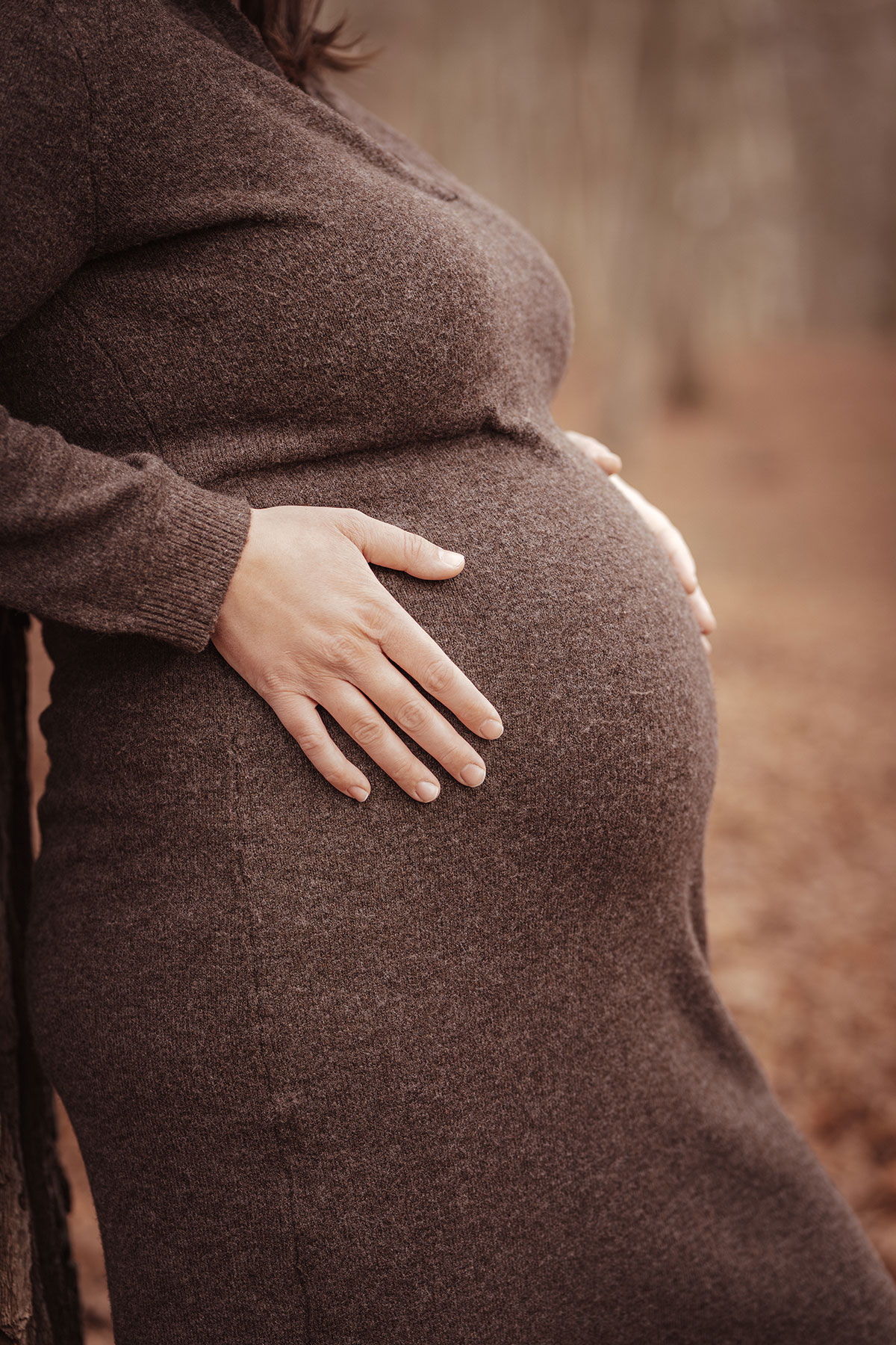 photo ventre d'une femme enceinte pour une séance photo grossesse en forêt