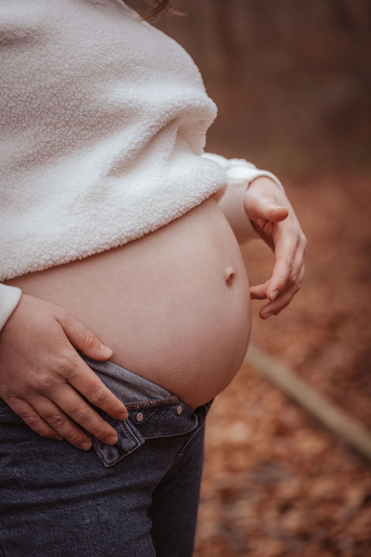 photo d'un ventre de femme enceinte lors d'un shooting photo en forêt